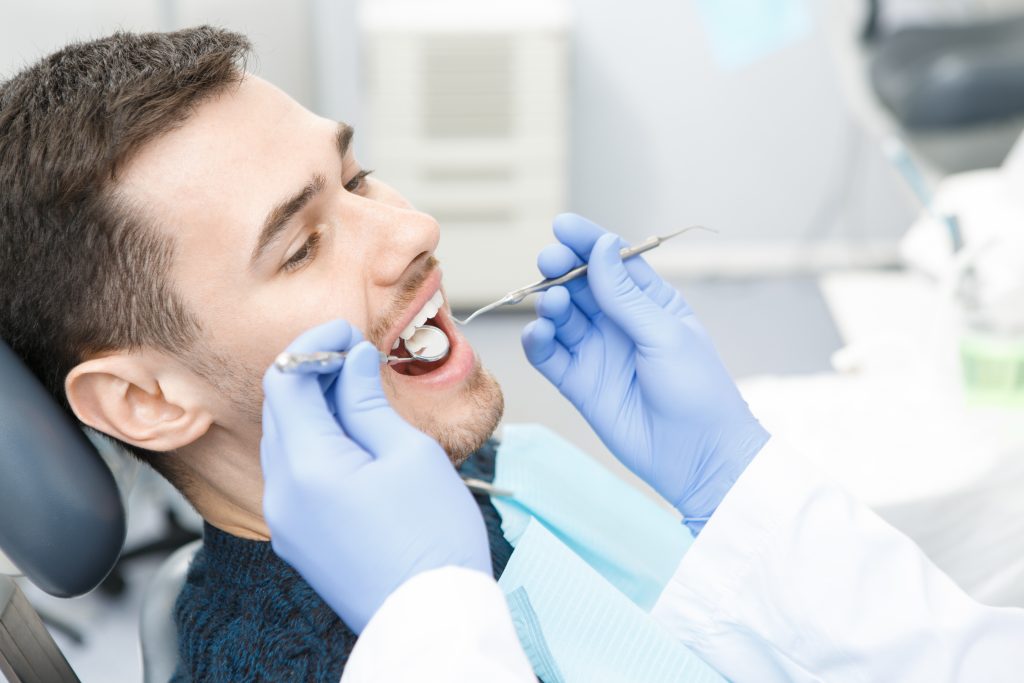 Man experiencing dental examination at dental appointment 