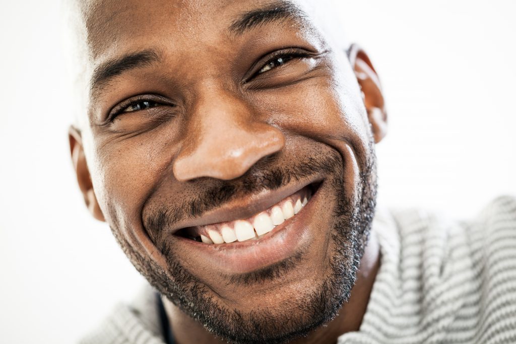 Close up of a black man with a beautiful smile. 