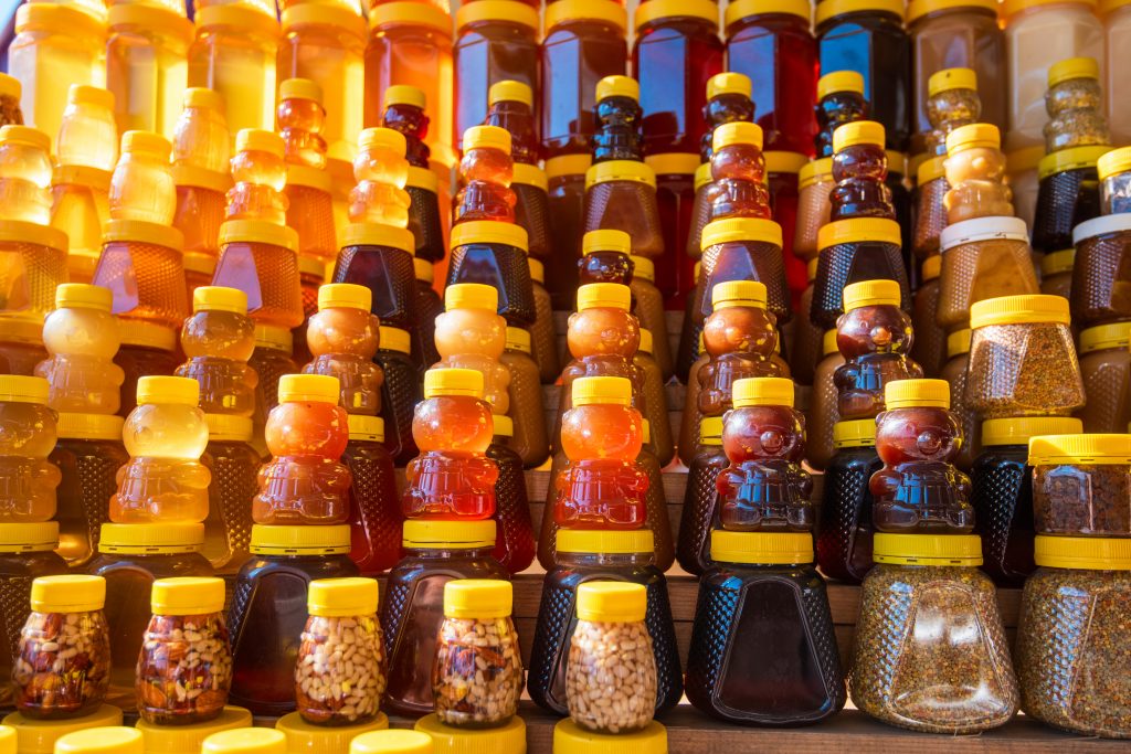 Fresh, organic honey in bear bottles form a market