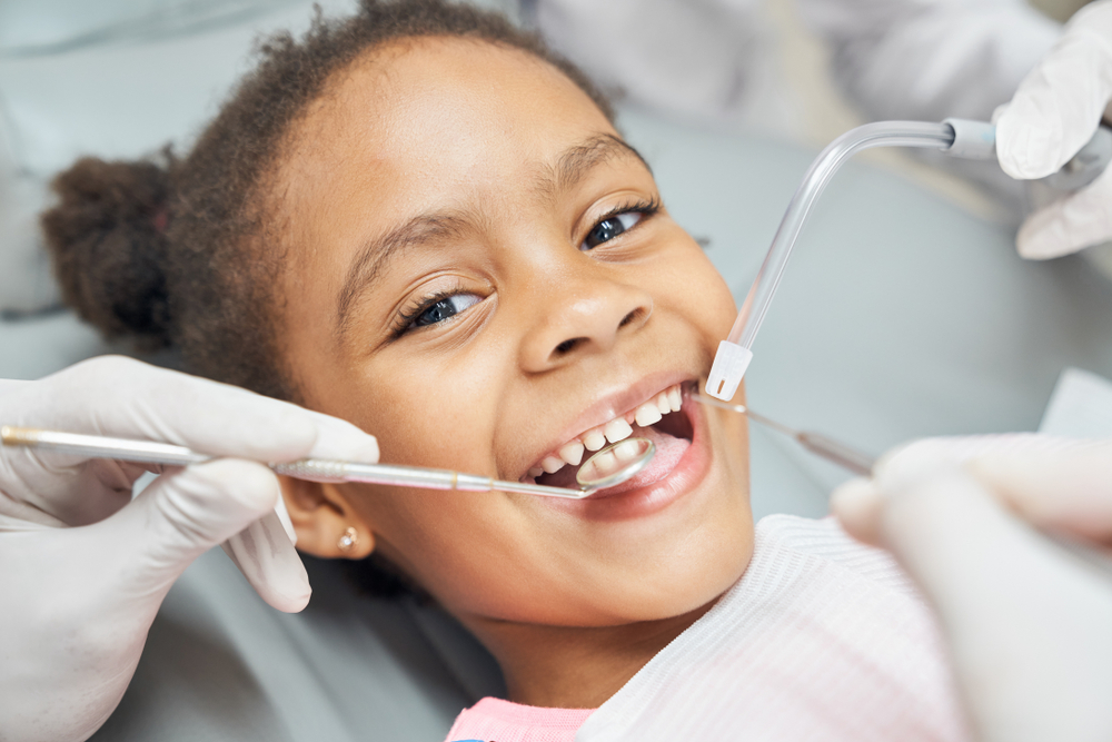  A little girl smiles during her dental exam at her Philadelphia family dentist. 