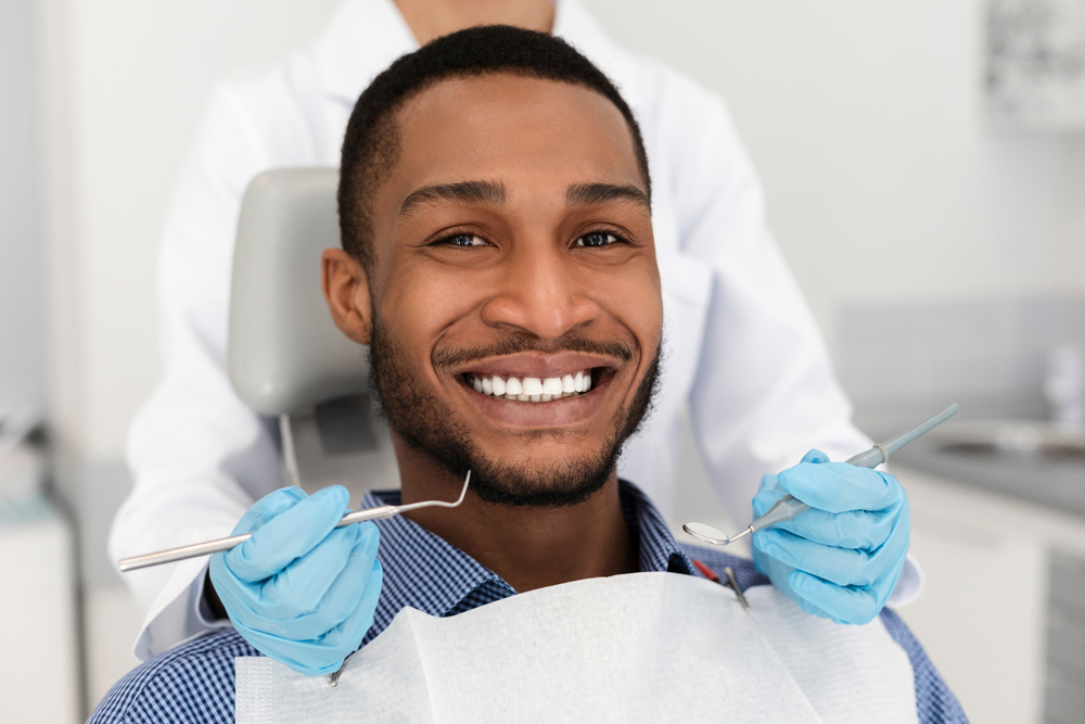  A man smiles while in an exam chair while getting ready to receive family dentist care in Philadelphia. 
