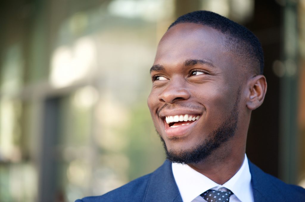  Attractive professional man with perfect teeth smiling. 